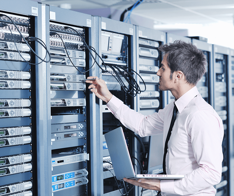 young engeneer business man with thin modern aluminium laptop in network server room